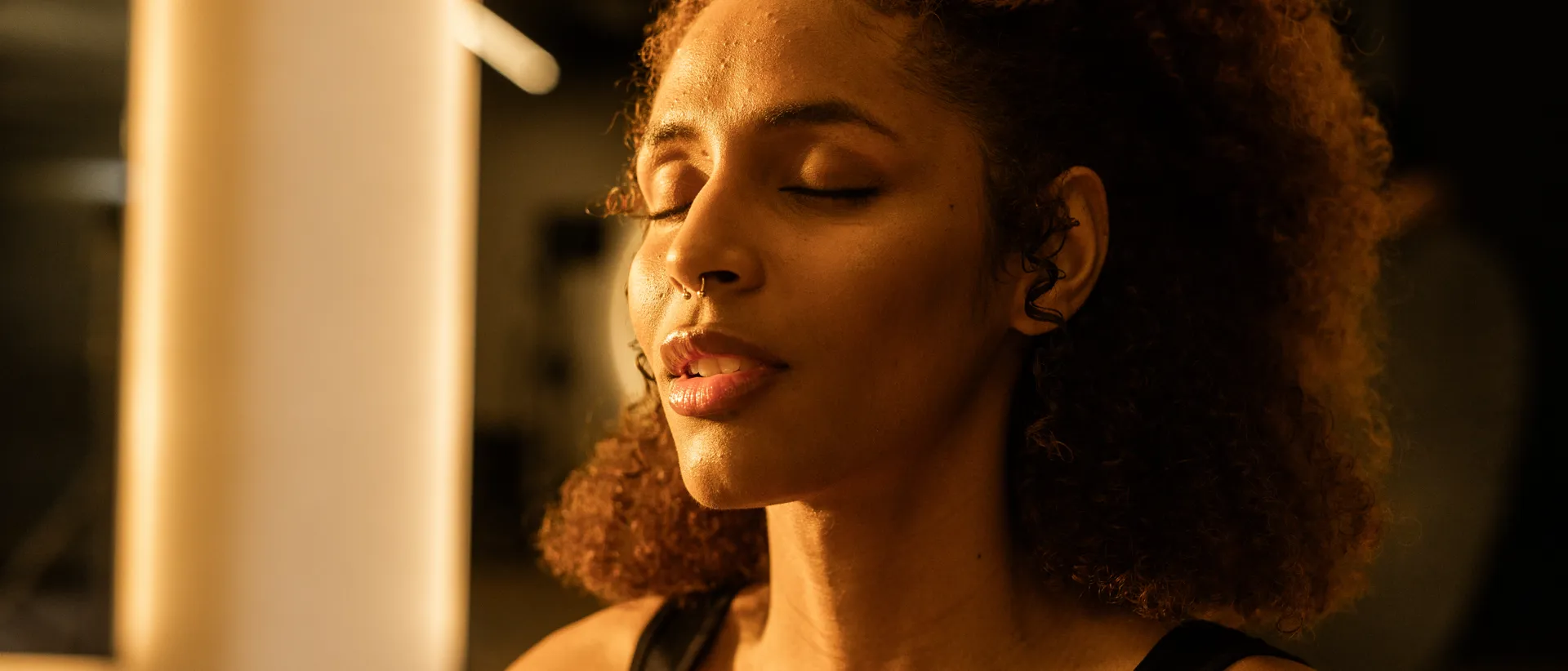A female member participating in a breath work exercise