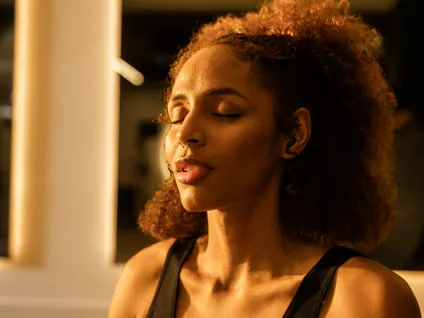 A female member participating in a breath work exercise