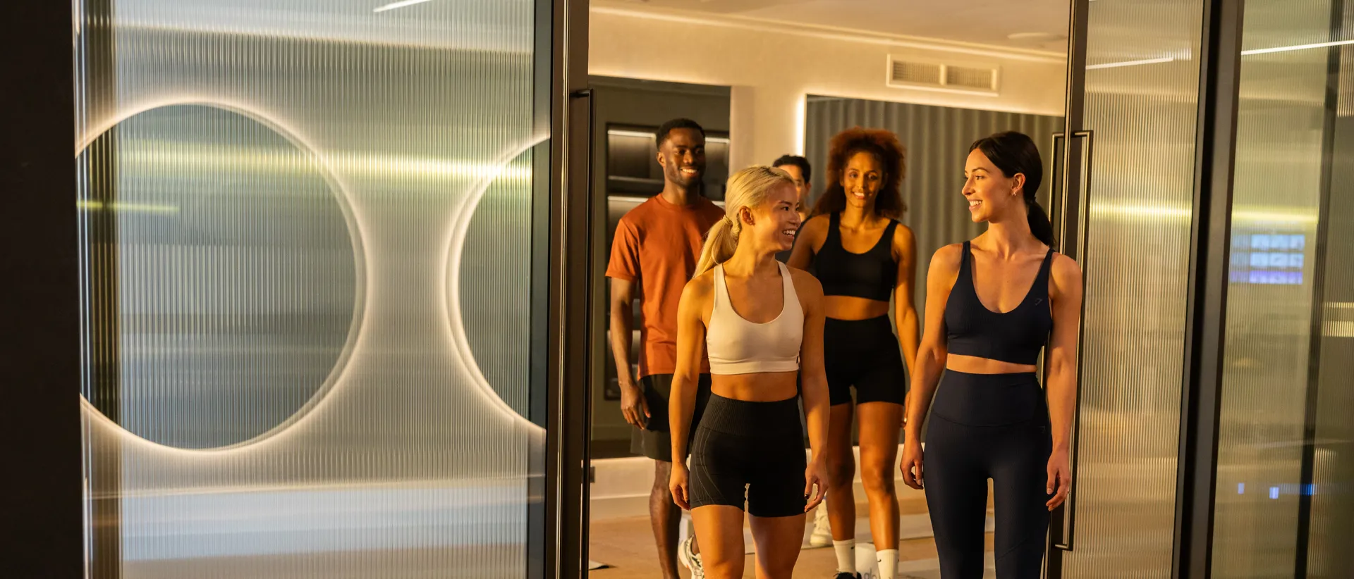 Group of members walking through the gym entrance together.